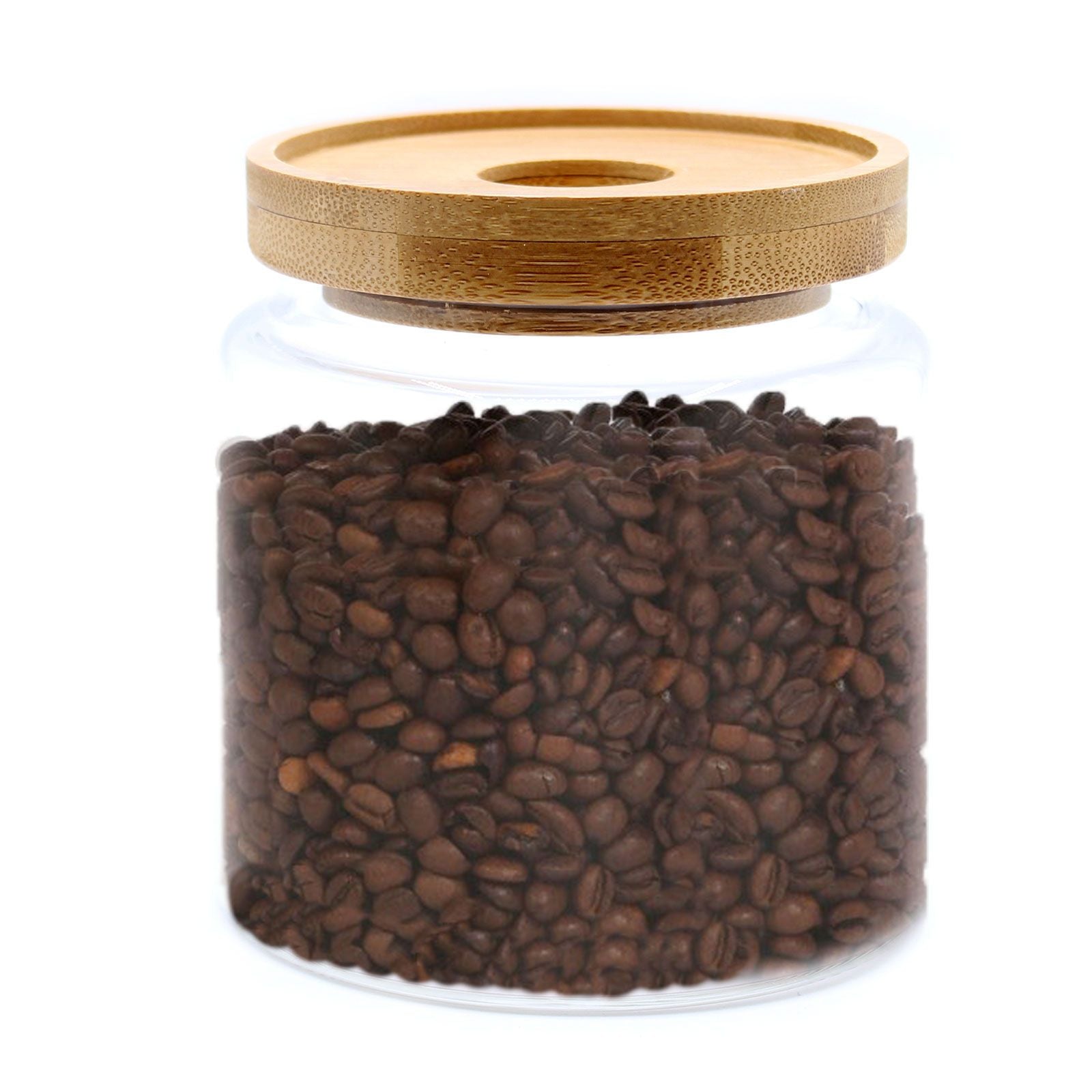Glass jar filled with coffee beans and a bamboo lid on a white background
