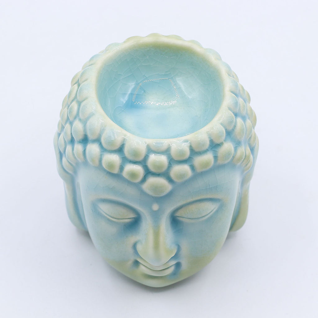 Ceramic Buddha head with a light blue interior on a white background