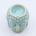 Ceramic Buddha head with a light blue interior on a white background