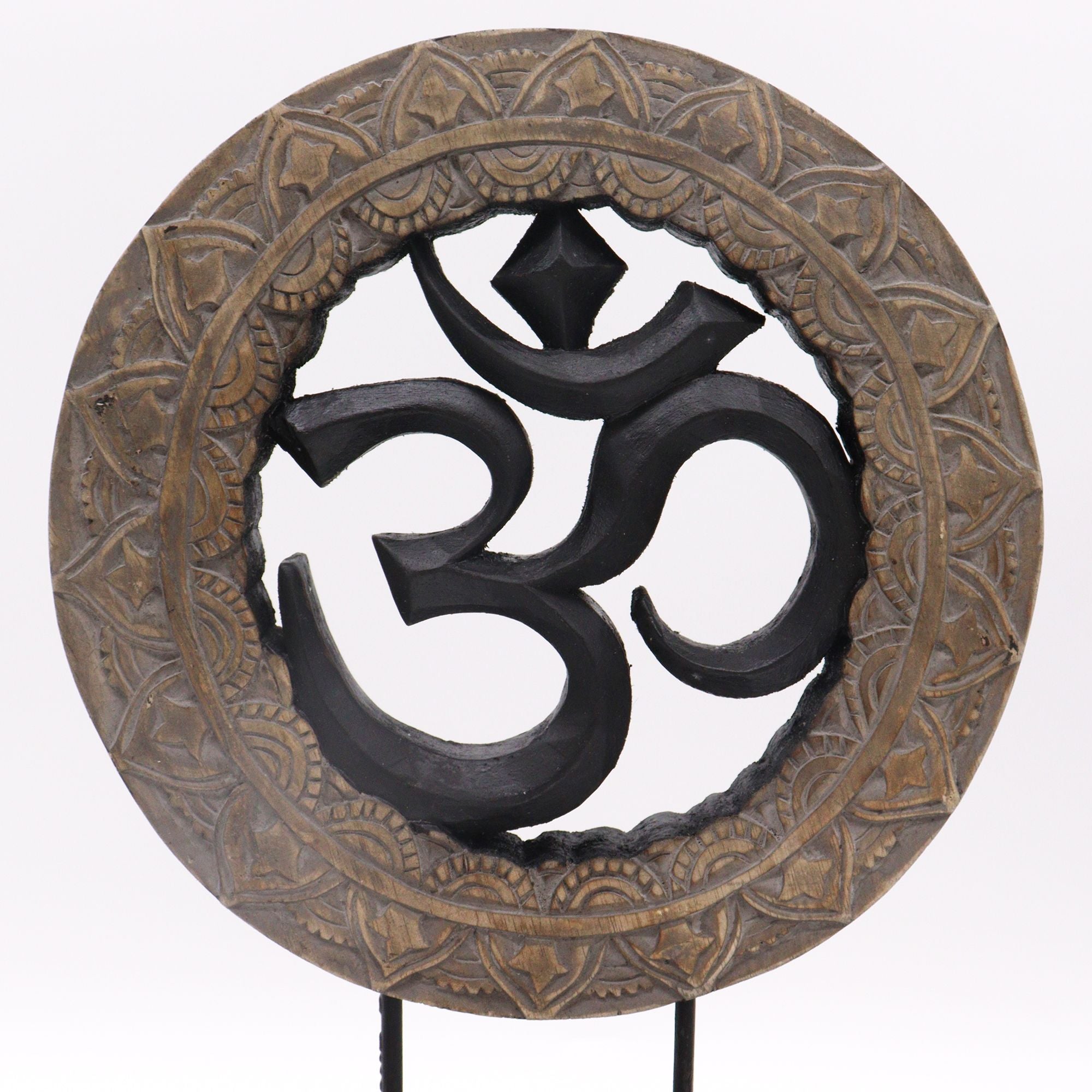 Decorative item with Om symbol in a circular, ornate frame on a white background