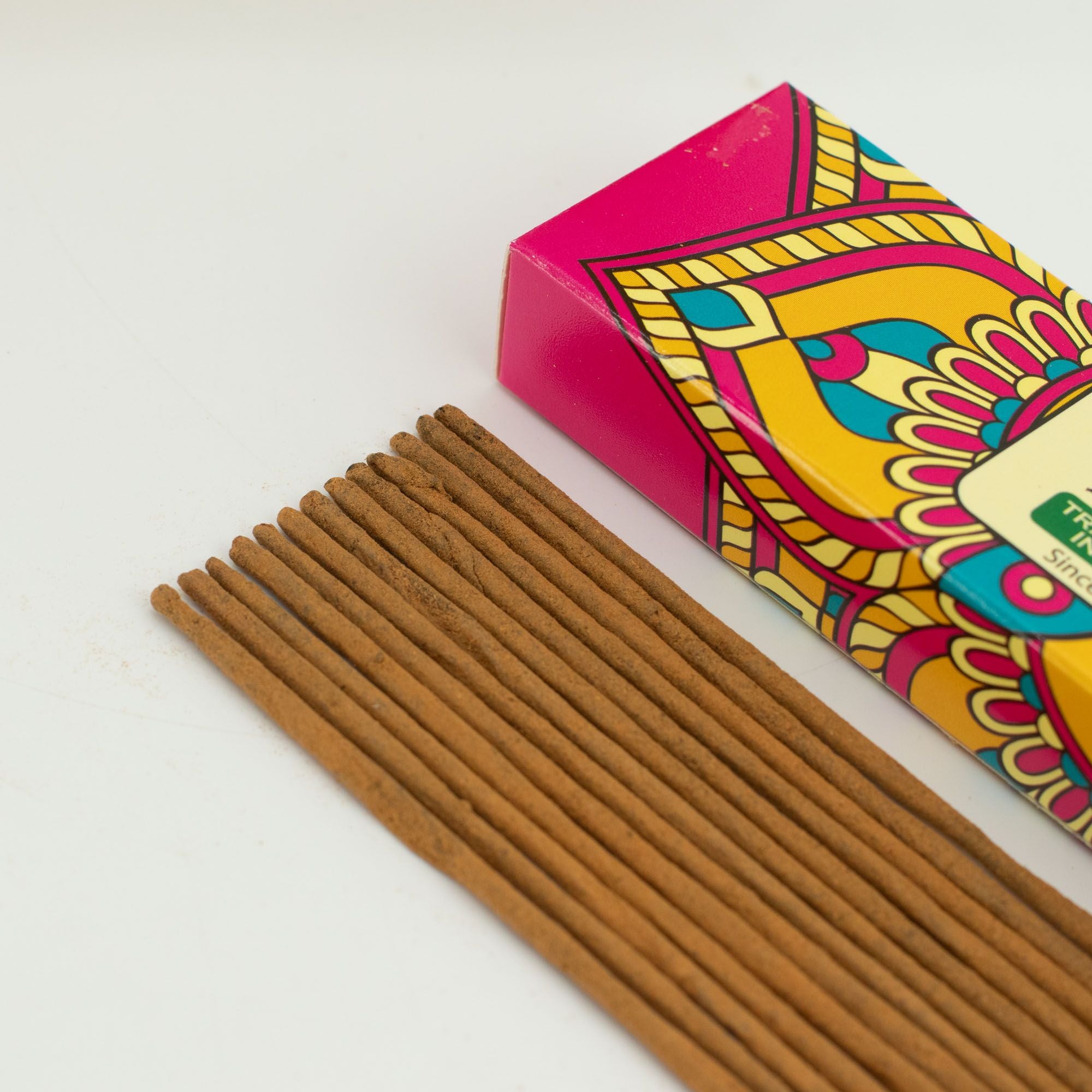 Incense sticks with a colorful box on a white background