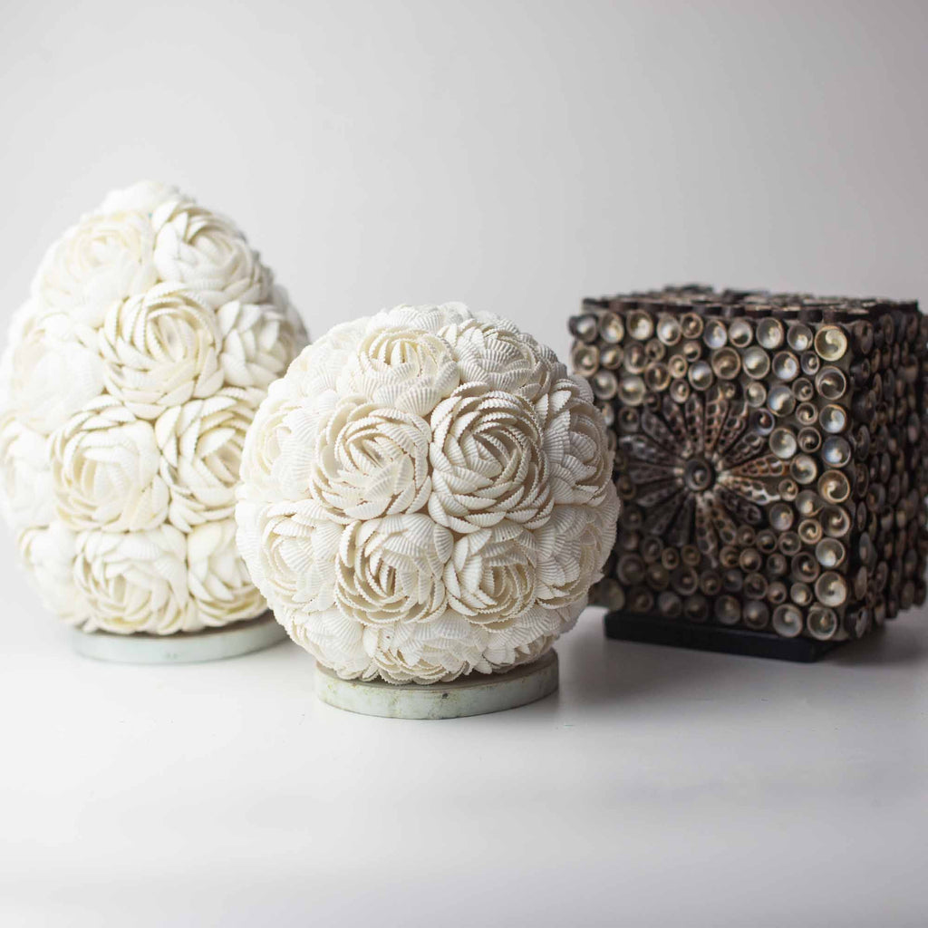 Decorative spherical objects with floral patterns on a white background