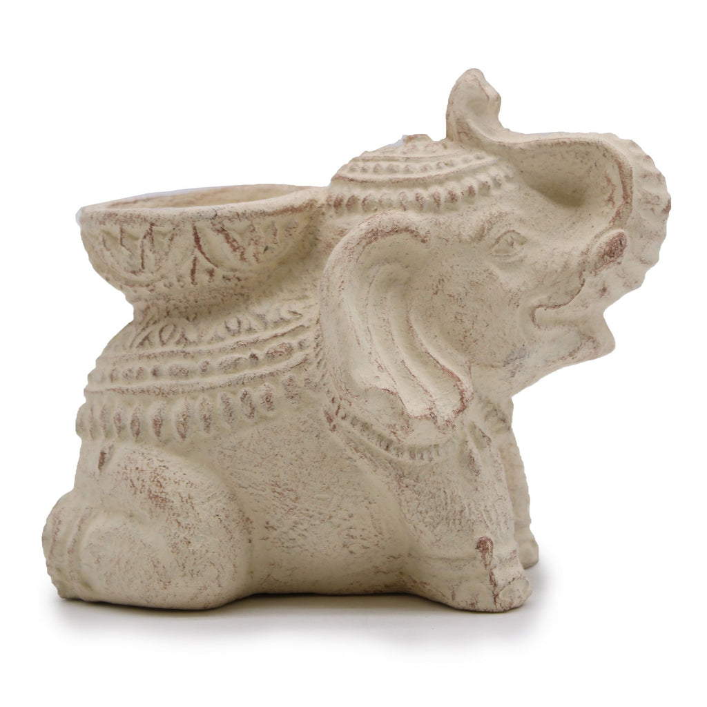 Decorative elephant-shaped object with intricate details on a white background