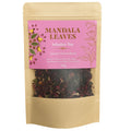 Tea package with pink label and visible tea leaves on a white background