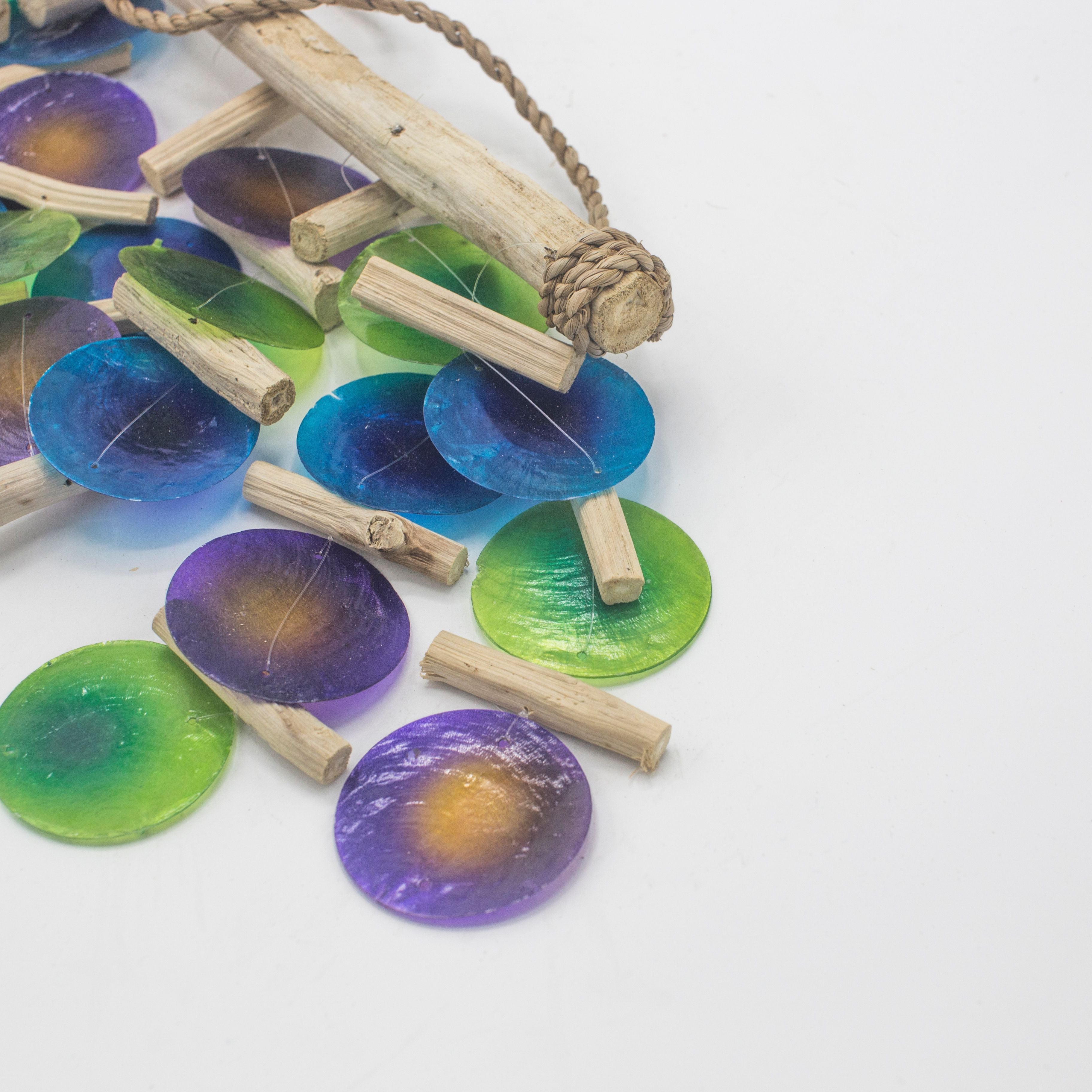 Colorful resin coasters with wooden stands on a white background