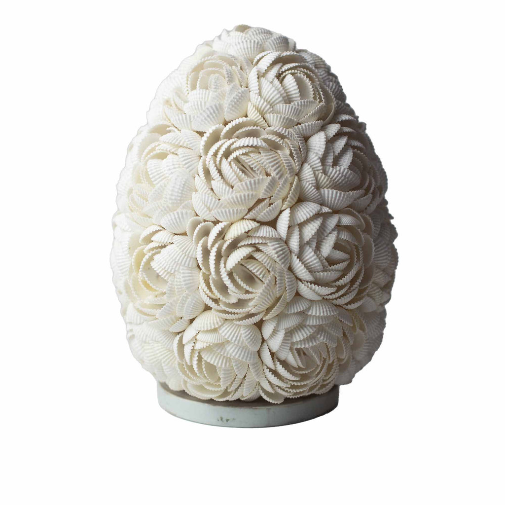 Decorative vase made of white seashells on a white background