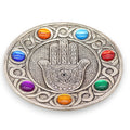 Decorative plate with Hamsa hand design and colorful stones on a white background