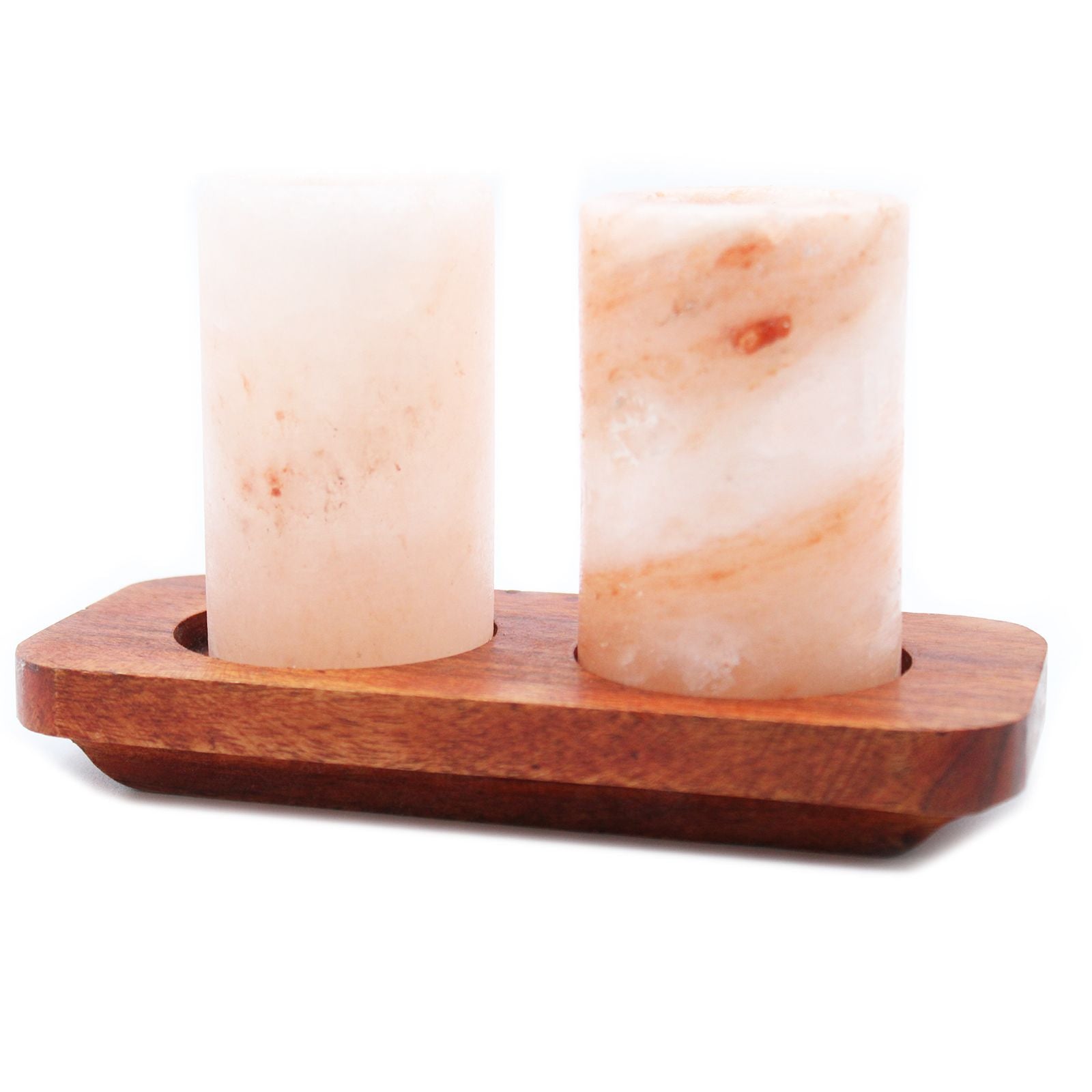Two Himalayan salt lamps on a wooden stand with a white background