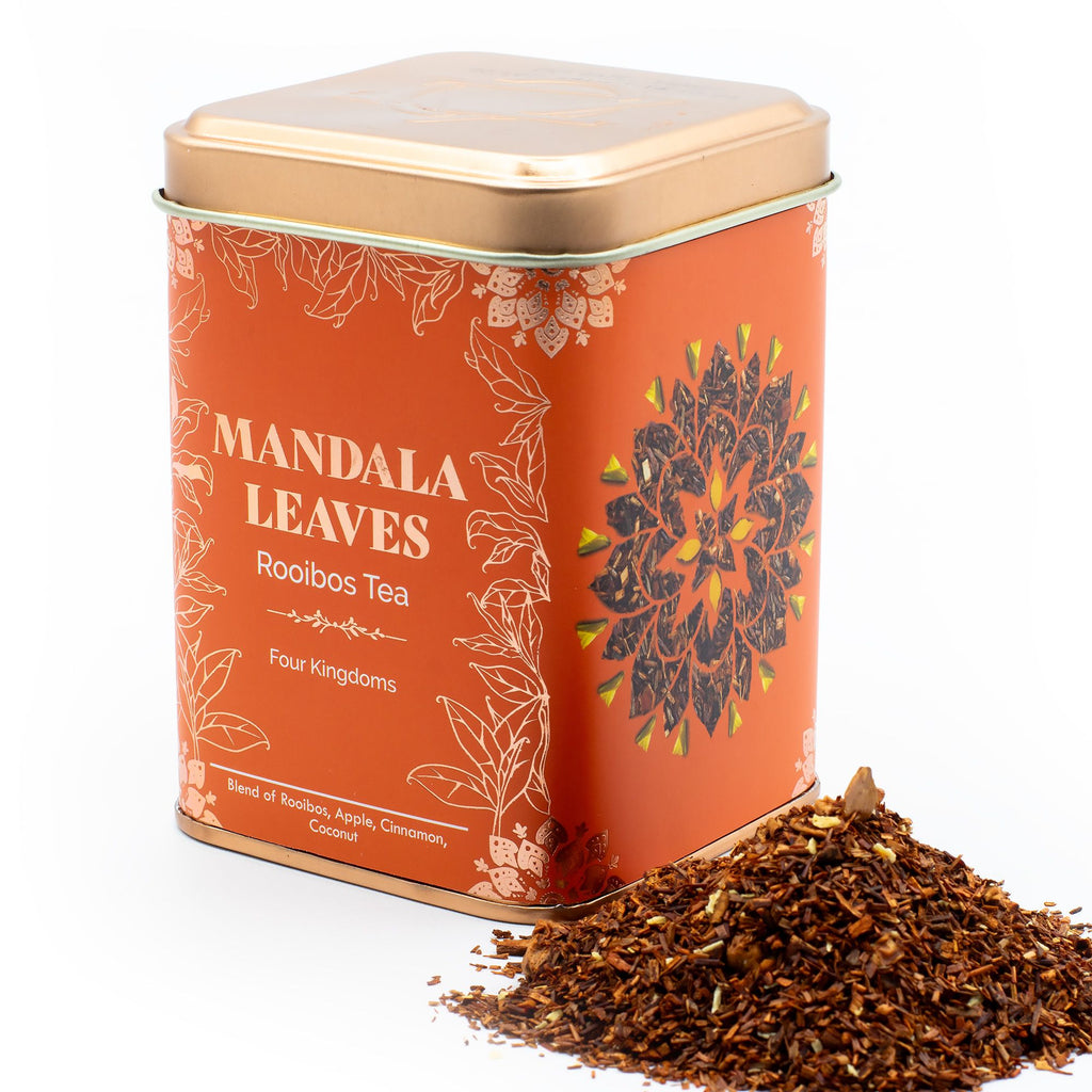 Tea canister labeled 'Mandala Leaves Rooibos Tea' with tea leaves spilling out on a white background