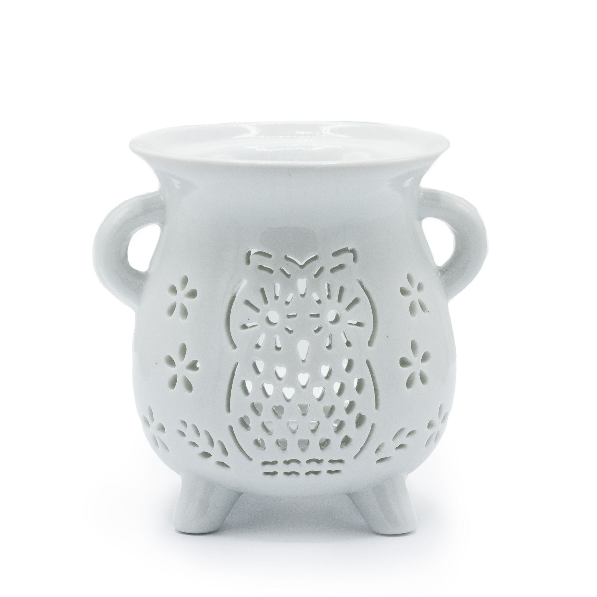 White ceramic owl-shaped lantern with cut-out design on a white background