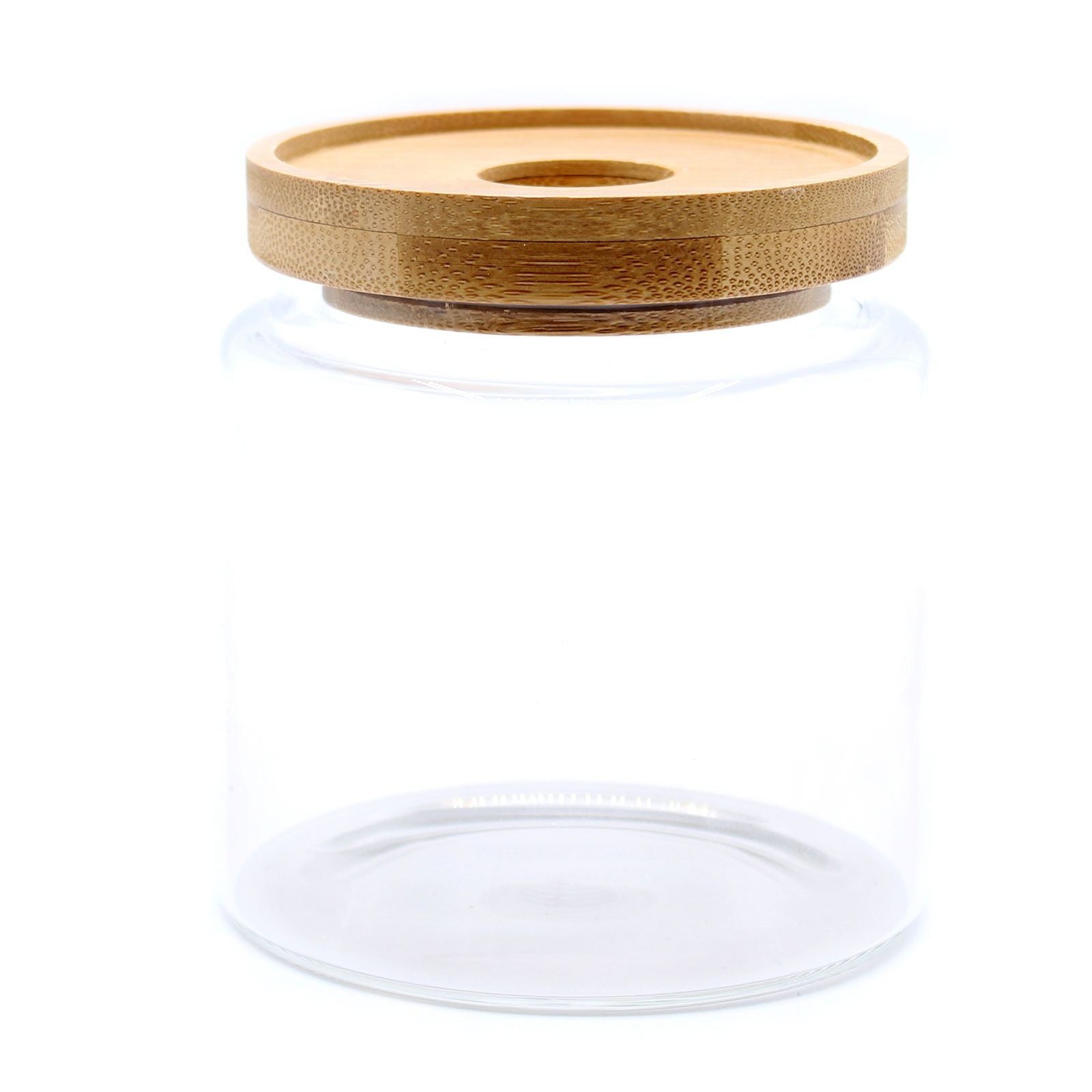 Clear glass jar with a wooden lid on a white background